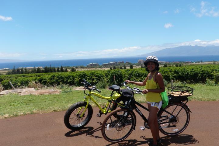 a man riding a bike down a dirt road