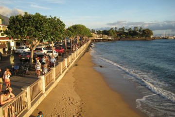 a group of people on a beach near a body of water